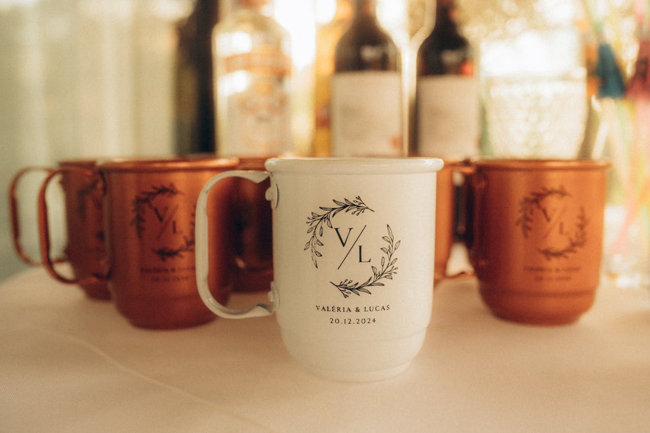 gallery-2 Custom white and bronze wedding mugs featuring initials and date, perfect for festive celebrations.